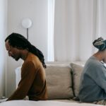 Couple sitting on the bed and talking about their intimacy issues.