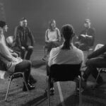 Group of people talking about the principles of the 12 steps.