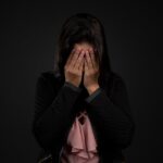 Woman covering her face.