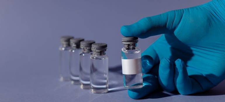 Person holding a vial of methadone.
