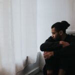 Man covering his ears while worrying about drug addiction myths and facts.