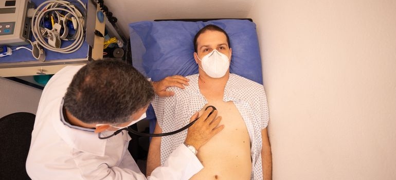 Doctor examining a male patient during a medical checkup.