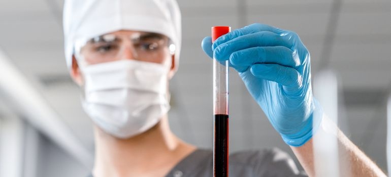 Medical professional examining a blood sample in a laboratory.