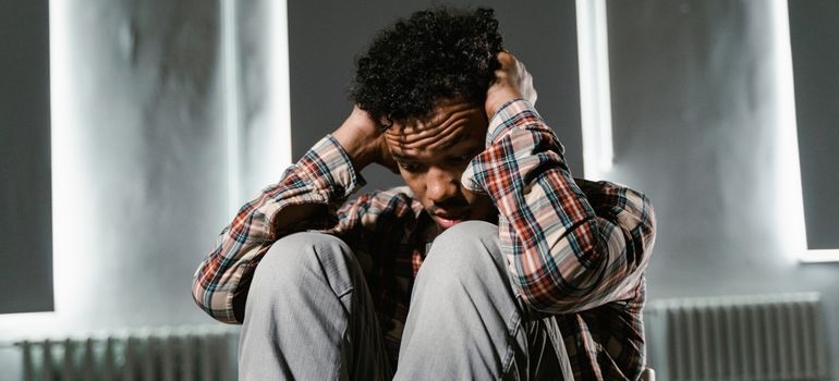 Man covering his ears while worrying about drug addiction myths and facts.