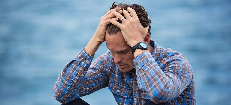 Man covering his ears while worrying about drug addiction myths and facts.