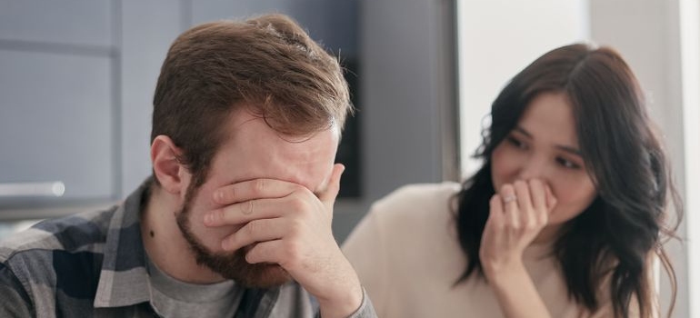 Woman supporting an upset man.