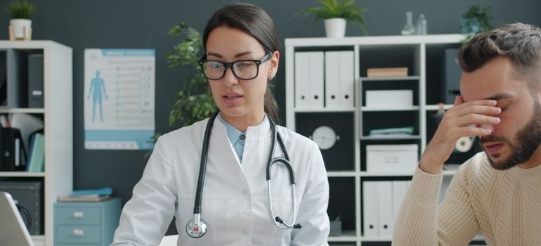 Male patient speaking with a doctor about medical test results and liver health.