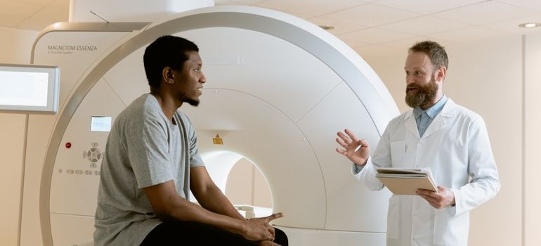 Male patient discussing alcohol-related dementia with a healthcare professional during a medical consultation.