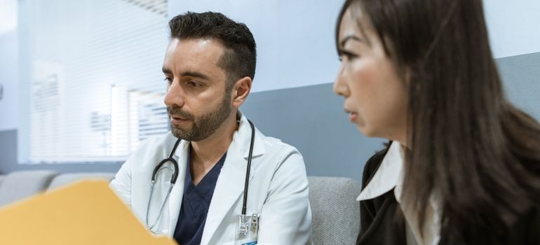 Doctor reviewing medical records with a patient for alcohol-related dementia.