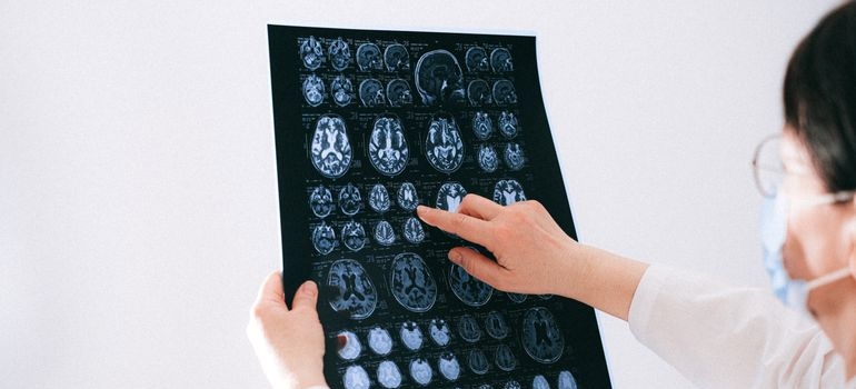 Doctor examining brain MRI scans during a neurological assessment.