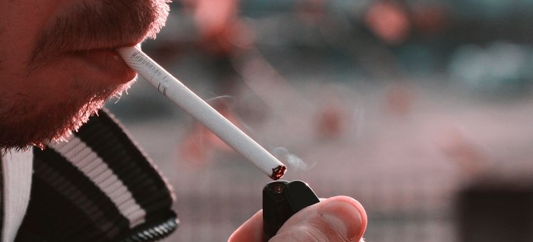 Man lighting a cigarette.