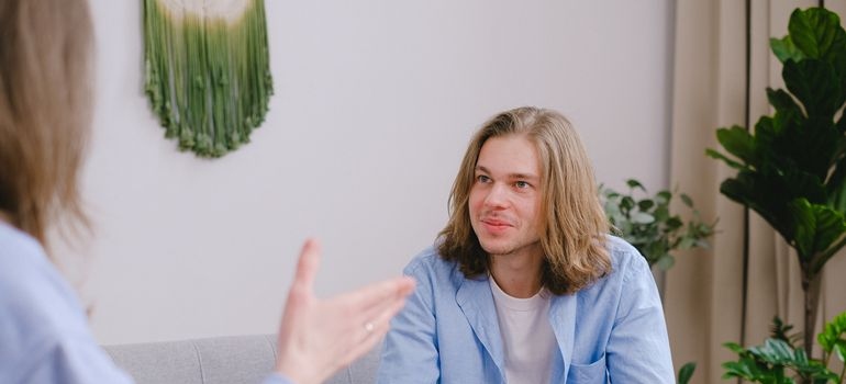 Man listening to his therapist talking about genetics and substance abuse.