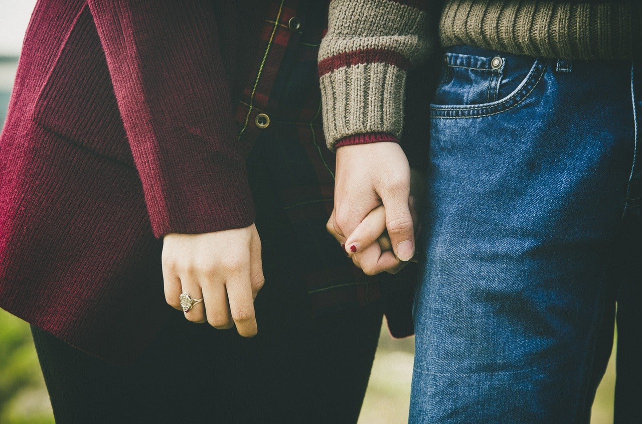 A couple holding hands.