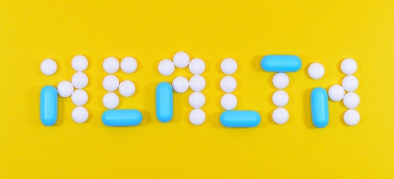 Spelling out the word health with pills.