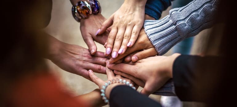 A group of people holding hands after finishing a residential treatment center Pennsylvania program.