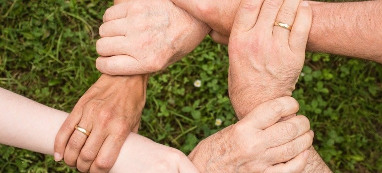 A group of people holding hands.