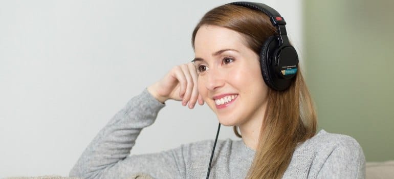 A woman listening to music as part of music therapy for addiction.