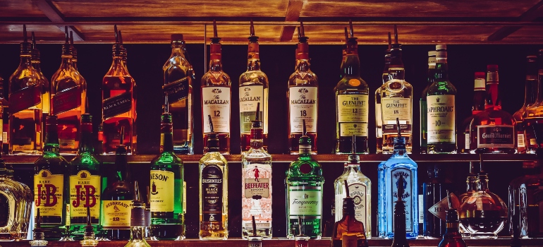 numerous alcohol bottles, symbolizing a way to spot the signs of young adult addiction