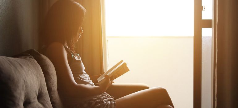 A woman reading a book about gateway drugs.