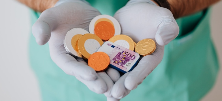 a doctor holding chocolate coins 