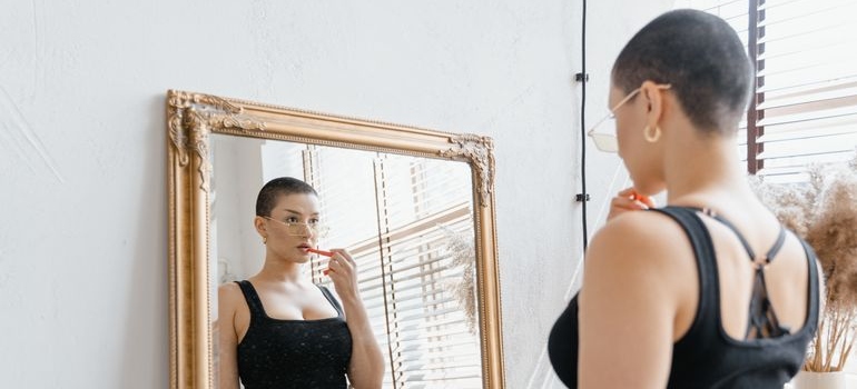 Woman looking at her reflection in a mirror.