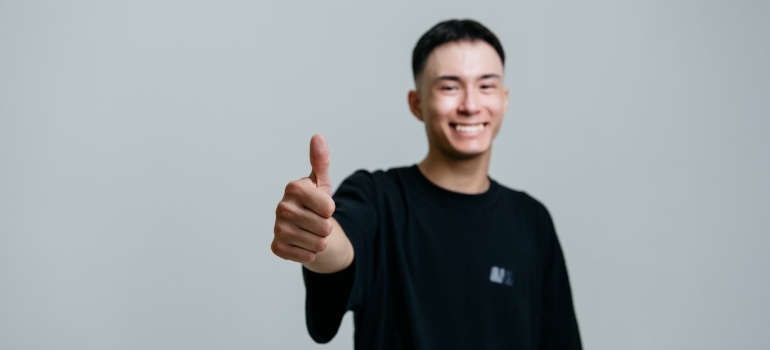 a person showing thumbs up after acheiving personal growth in life after addiction recovery