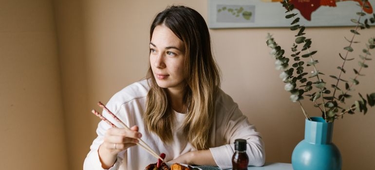 Woman eating a meal at a table.