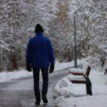 a man walking through a snowy street