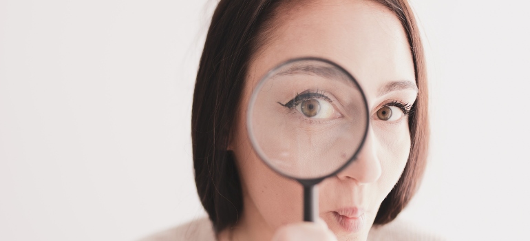person looking through a magnifying glass