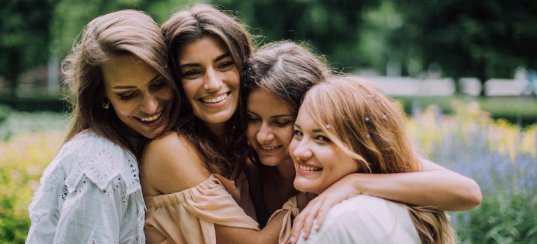 A group of happy women hugging.