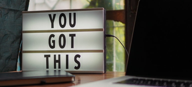 "You got this" sign next to a laptop