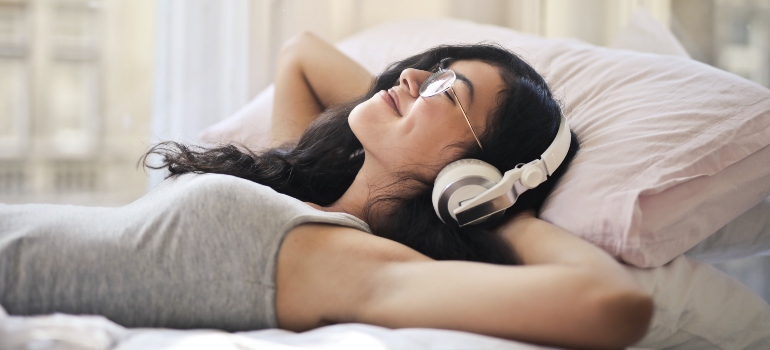 person listening to music, trying to understand how music helps individuals in rehab