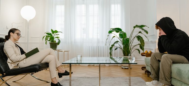 Patient discussing their treatment plan with a therapist in a calm office.