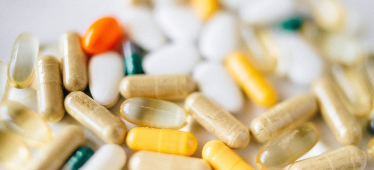 a pile of prescription medications in medication-assisted treatment