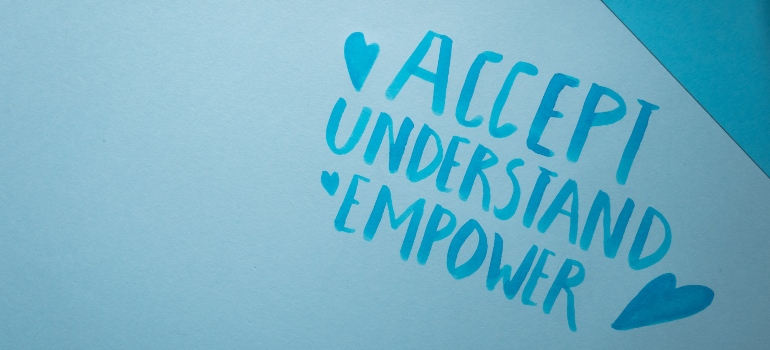 the words "accept" "understand" and "empower" on a blue background