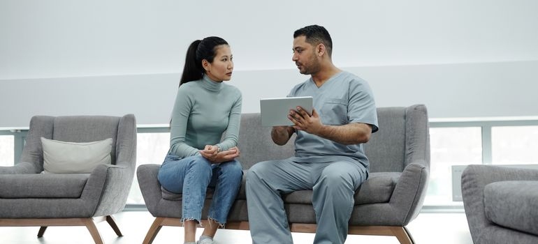 Patient asking a nurse about the difference between sober living homes and halfway houses.