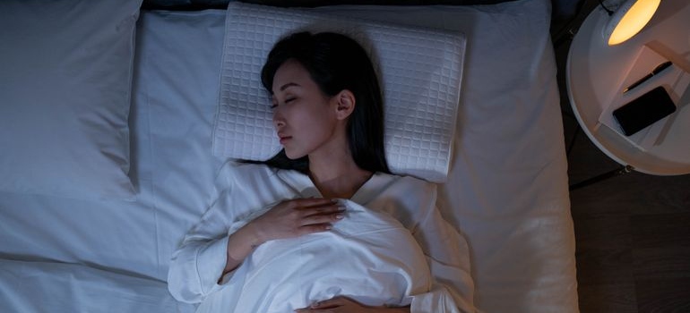 Woman resting in a calm room while recovering from anxiety after drinking.