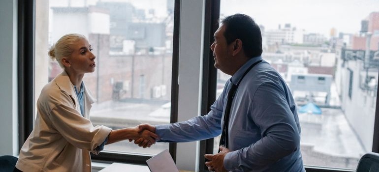 Woman shaking hands with an employer.