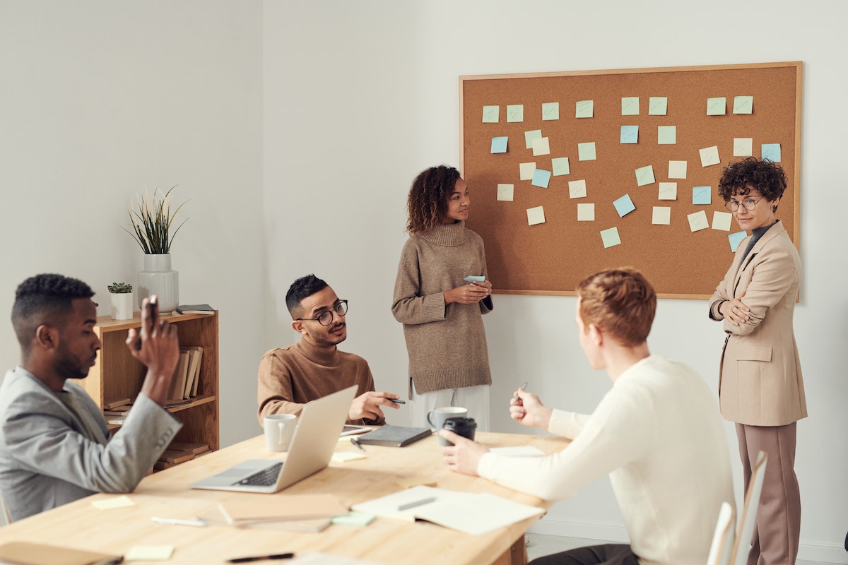 many people talking to each other in an office