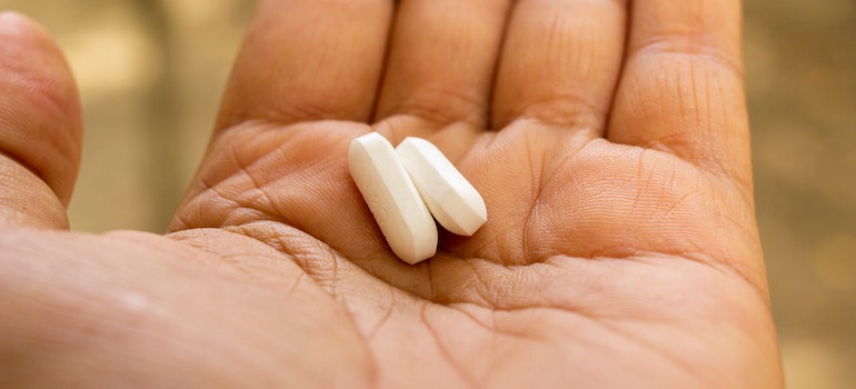 Two Xanax pills on a person's palm