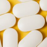 Xanax pills on a yellow surface
