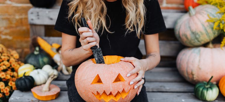 woman carving a pumpkin 