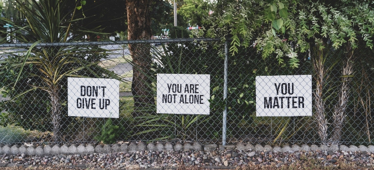 Motivational signs on a fence.