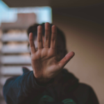 a person holding their hand as a way to set boundaries to with a loved one in recovery