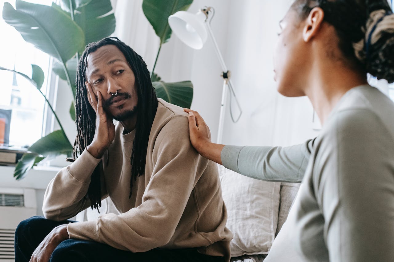 A therapist consoling her patient