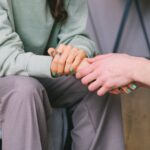 two persons holding hands representing Benefits Offered By The Sober Living Homes in PA