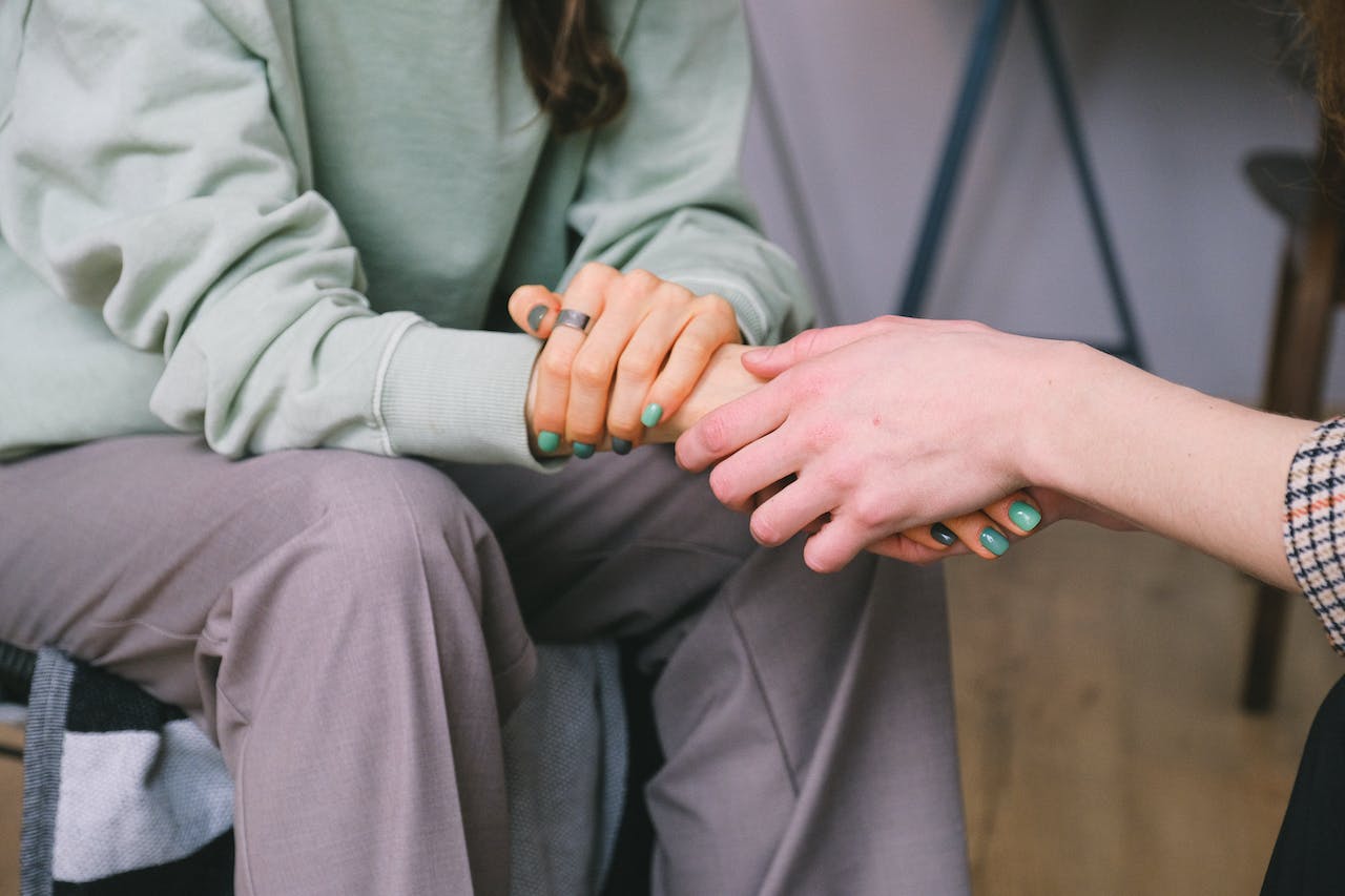 two persons holding hands representing Benefits Offered By The Sober Living Homes in PA