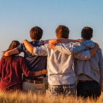 four people hugging
