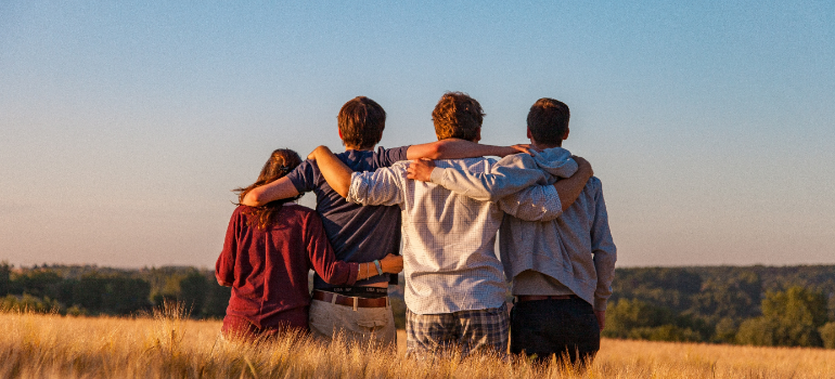 four people hugging aftercare planning