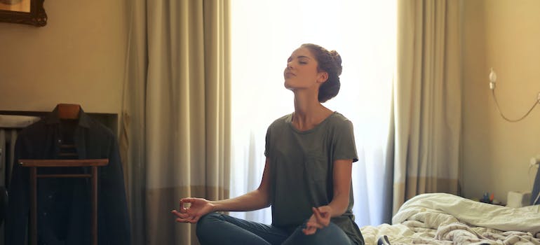 woman meditating after creating a recovery-friendly home environment in PA